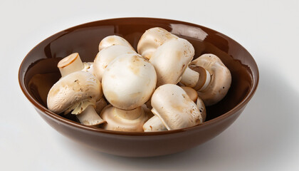 Fresh white mushrooms champignon in brown bowl on white background.