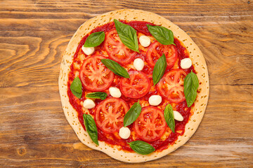 Tasty pizza on wooden background