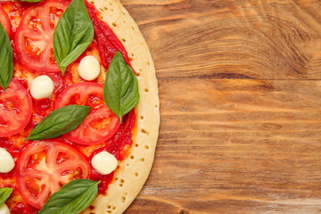 Tasty pizza on wooden background