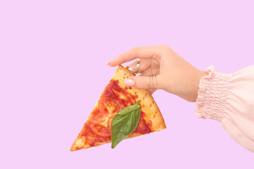 Woman holding slice of tasty pizza on lilac background