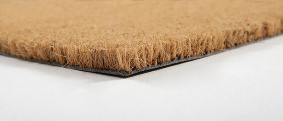 Natural brown coconut fiber doormat. Plain natural dry carpet and dirt outside your entrance,...
