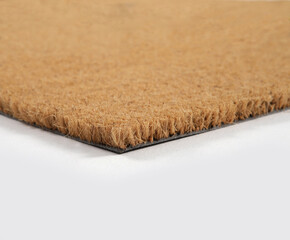 Natural brown coconut fiber doormat. Plain natural dry carpet and dirt outside your entrance, Detail, closeup of fiber and base on white background