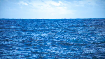 Fototapeta premium Summer sea background. Texture of water surface. Shining blue water ripple pattern.