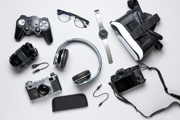 Set of different devices with eyeglasses on white background