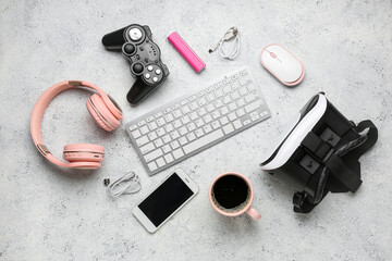 Composition with different gadgets and cup of coffee on light background