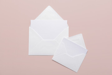 Paper envelopes with blank cards on color background