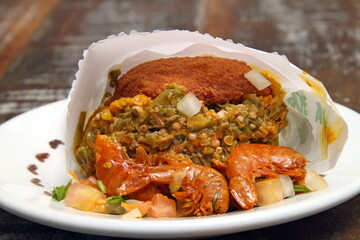 Acarajé with caruru and dried shrimp, a classic Bahian delicacy