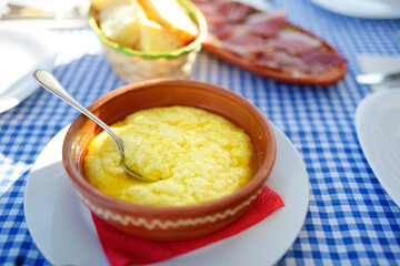 Traditional rustic treat in Montenegro is kachamak. Kachemak is a corn porridge mixed with crushed potatoes and kaymak, sheep cheese. National cuisine