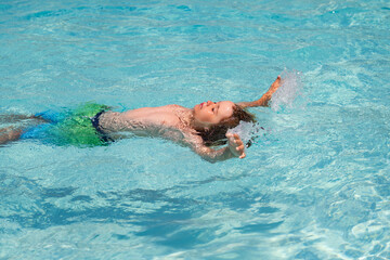 Children playing in swimming pool. Kids holidays and vacation concept. Summer kids fun.