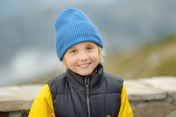 Portrait of cute child tourist in Lovcen national park, Montenegro.