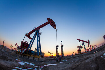 In the evening, oil pumps are running, Silhouette of beam pumping unit
