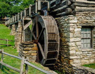 wooden waterwheel in motion at a reproduction 1800's mill