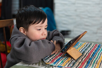 Boy using a smartphone to play video games. Digital entertainment concept.