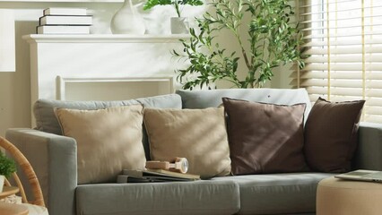 home interior design detail of Modern clean living room with soft and cosy sunlight pillow upholstery cushion arrange on white sofa dolly shot close up,home sweet home background