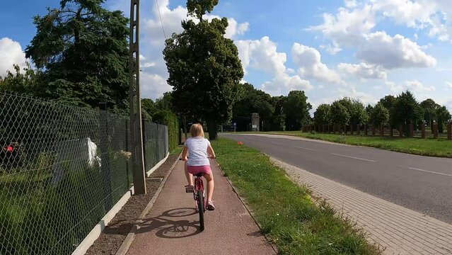 child riding a bike on a bike path