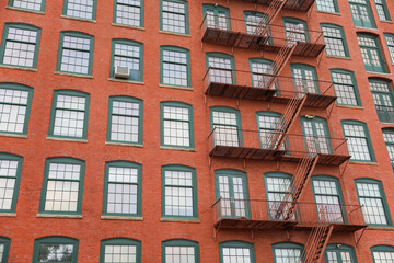 Fire escape building, A symbol of urban life's challenges and resilience. Escape routes, freedom, and safety amidst city's chaos
