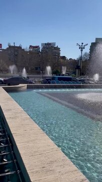 HD Video, vertical orientation - Springs of water with playful water vapours in the background, at the Bucharest Artesian Fountains (Fantana lui Bucur) in Romania-April 2022.