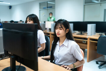 Asian girls students studying computer subject in computer classroom