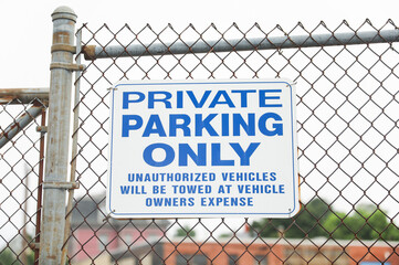 No parking sign on street; Symbol of restriction, order, and urban rules; Empty space implies compliance and traffic control