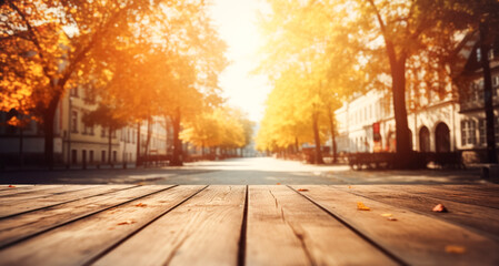 Empty wooden table top against the backdrop of a city street, warm autumn day. The concept of autumn