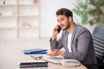 Young male employee working in the office