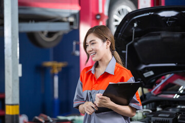 Female employee of customers in car maintenance department. Car center accountant. woman holding clipboard checking maintenance list service auto repair workshop.