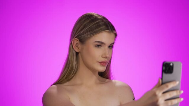 Young caucasian woman searches perfect camera position for beauty photo