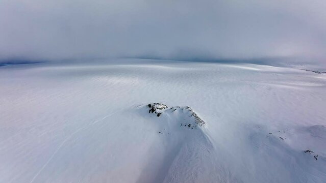 Aerial landscape view of Myrdalsjokull glacier covered in snow in Iceland, on a cloudy evening