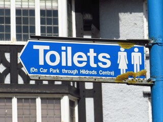 sign for toilets on the street