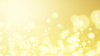 キラキラと光る金色の光。玉ボケ。（横長）