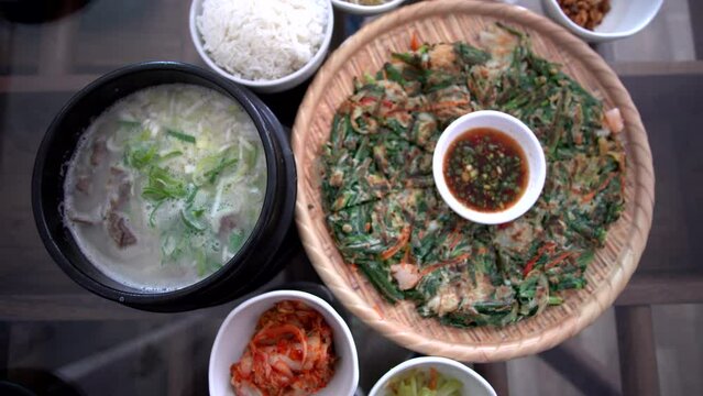 Korean food seafood pancake ox beef bone soup and side dishes Seolleongtang Haemul pajeon banchan