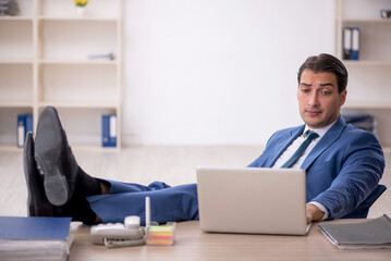 Young male employee working in the office