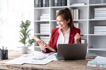Fototapeta na wymiar Smiling confident successful businesswoman leader happy moment about her work, attractive young Asian accountant female joyful smiling while working in office