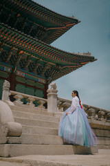 Tourist girl wearing a traditional korean hanbok at the Changgyeonggung Palace, Seoul, South Korea.