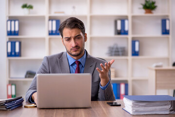 Young male employee working in the office