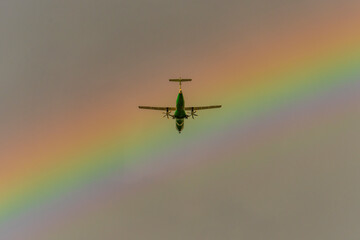 airplane in the sky aver the rainbow