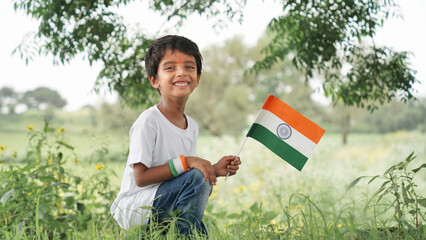 Cute little boy with Indian National Tricolour Flag, Isolated over nature background. Suitable for...