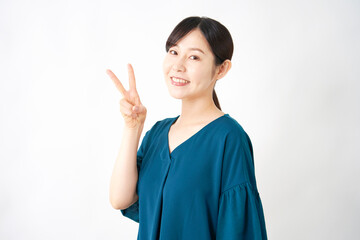 ピースサインするミドルエイジの女性　白背景
