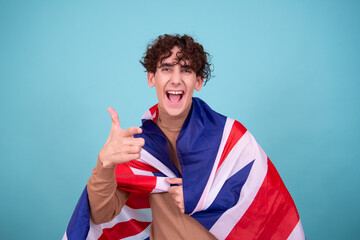 Emotional guy posing in the studio with the British flag.
