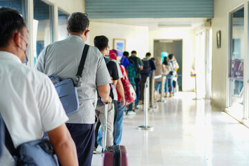 Crowded Gates: Passengers Waiting in Line for Their Flight