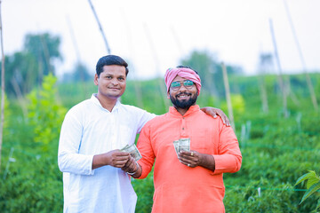 Indian farmer giving money to his worker