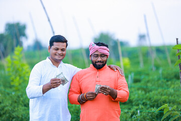 Indian farmer giving money to his worker