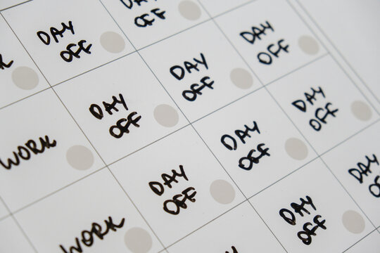 Magnetic board writing 4 day work week calendar with three weekend days off four day working week concept. Modern approach doing business short workweek. Effectiveness of employees. Productivity and