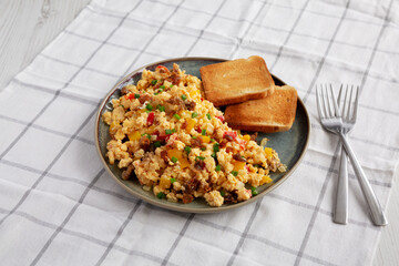 Homemade Fiesta Scrambled Eggs with Peppers and Toast on a Plate, side view.
