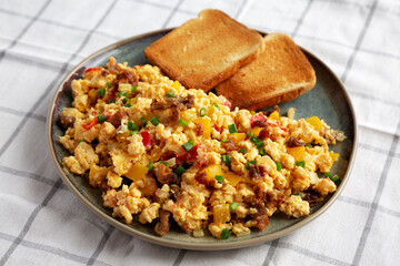 Homemade Fiesta Scrambled Eggs with Peppers and Toast on a Plate, side view.