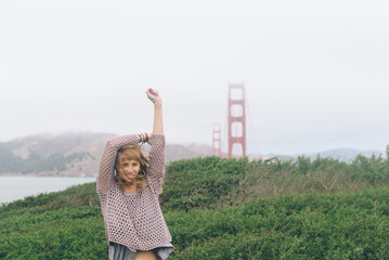 Young Woman in Purple Shirt by The Golden Gate Bridge