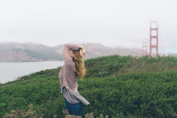 Young Woman In The Wind By The Golden Gate Bridge California