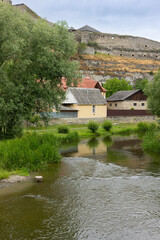 Fototapeta na wymiar Houses in the river valley near the canyon