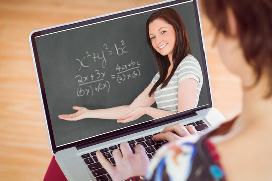 Caucasian woman looking at teacher teaching mathematics on laptop screen during online class