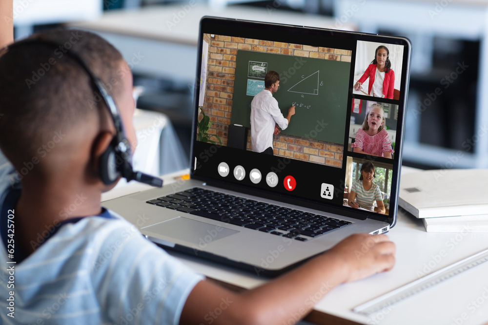 Poster African american boy in headphones listening to teacher teaching over video call on laptop